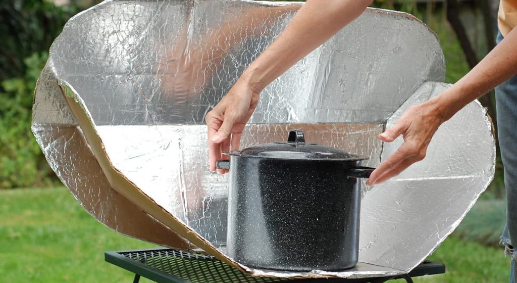 removing a pot from a solar cooker oven